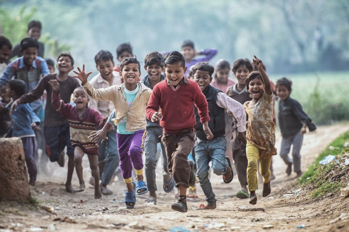 MATHURA, INDIA - Feburary 23,2018: Group of boisterous Indian children running for photograph in Agra, Uttar Pradesh, India.